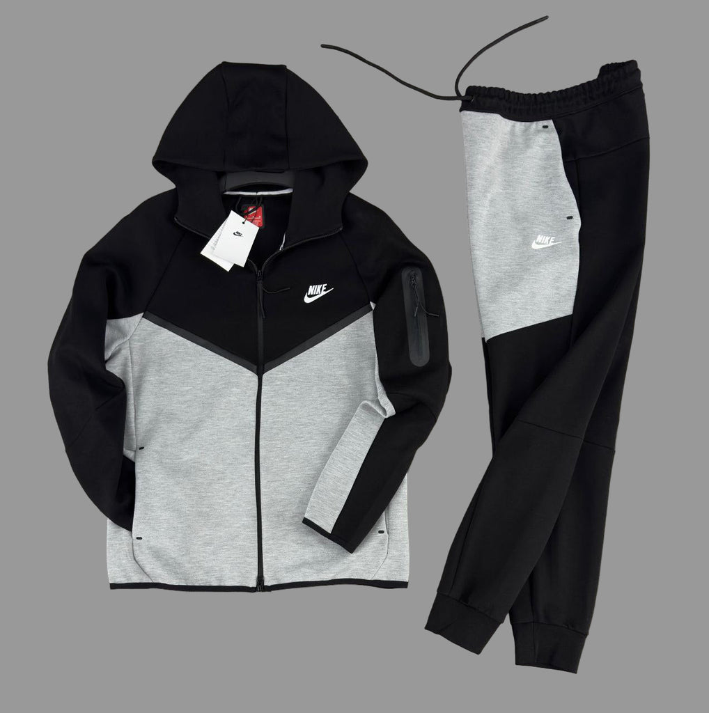 Męski dres Nike Tech Fleece, w kolorze czarnym i klasycznej szarości, z czarnymi liniami i kieszenią na rękawie z białym logo